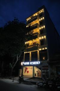 a tall building with a sign that reads hunter hospitality at Le Kumar Residency in Pondicherry