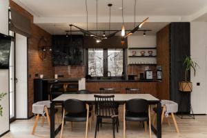 a dining room with a table and chairs at Die SONNE in Bukovel