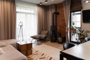 a living room with a couch and a table at Die SONNE in Bukovel