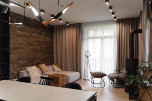 a living room with a couch and a brick wall at Die SONNE in Bukovel