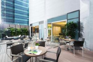 a patio with tables and chairs on a building at iclub Fortress Hill Hotel in Hong Kong