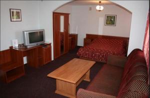 a hotel room with a bed and a television at Zhovtnevyi in Vinnytsya