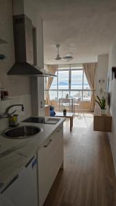 a kitchen with a sink and a view of the ocean at Brisa al Mar in Bellreguart