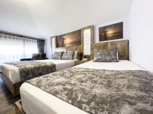 two beds in a hotel room with white walls at Castle Light Boutique in Alanya
