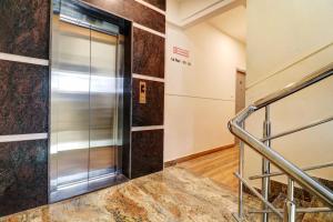 an elevator in a building with a staircase at Townhouse Ecity Inn in Bangalore