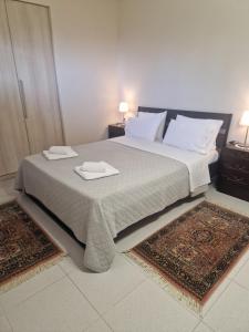 a bedroom with a large bed with two trays on it at Ktima Lena in Órmos