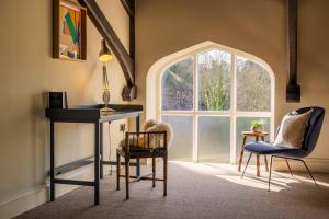 a room with a table and chairs and a window at Luxury Riverside Duplex Apartment for 4 in Wilton