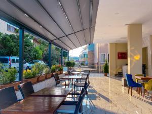 a restaurant with tables and chairs and windows at Castle Light Boutique in Alanya