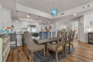 a kitchen and dining room with a table and chairs at Turquoise 1908C in Orange Beach +50 photos