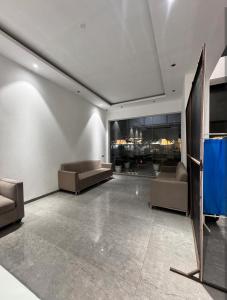 a living room with couches and tables at Hazelnut -Expo India centre in Greater Noida +15 photos