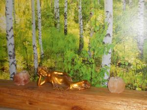 a bronze statue sitting on a shelf in front of a forest at Bed & Breakfast Nettuno in Trento