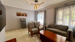 a living room with a couch and a table at Dolphin AIR B&B in Arusha