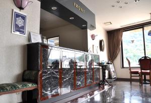a large fish tank in a room with chairs at ホテルマルセイユ in Shimoda +12 photos