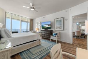 a bedroom with a large bed and a living room at Turquoise 1908C in Orange Beach