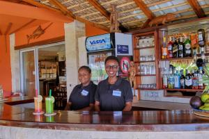 two men standing at a counter in a bar at VILLA PANORAMA NOSY BE in Nosy Be +106 photos