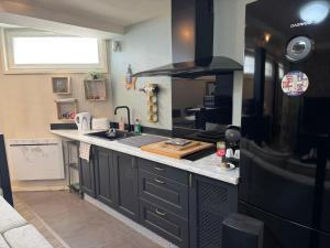 a kitchen with a sink and a counter top at Relaxed appartment in Melun