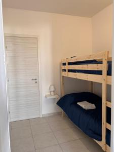 a bedroom with a bunk bed and a door at A Due Passi dal Centro in Favignana +8 photos