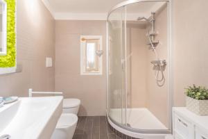 a bathroom with a shower and a toilet and a sink at La Casa di Pietro in Blevio +39 photos