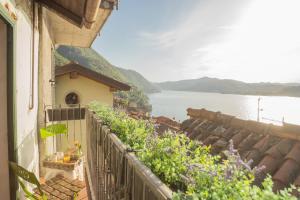 a balcony of a house with a view of the water at La Casa di Pietro in Blevio