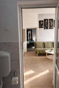 a living room with a couch and a glass door at Apartament Salina Turda in Turda +5 photos