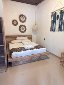 a bedroom with a wooden bed in a room at Villa Bianca Lovina by GEMA MANAGEMENT BALI in Lovina +18 photos