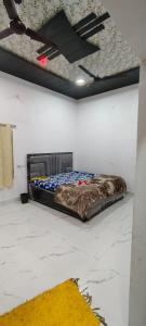 a bed sitting on the floor in a room at Thakur place in Mathura