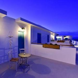 a white room with a table and a room with a bed at Little Blue Doors Studios in Samos