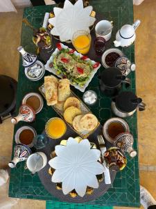 a table with a bunch of food and drinks at Riad julines in Marrakesh