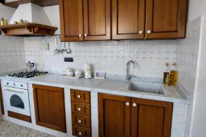 a kitchen with a sink and a stove at Casa Lapè in Levanto