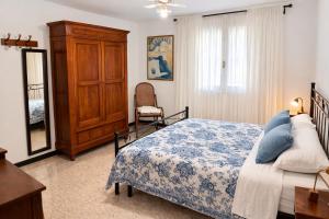 a bedroom with a bed and a dresser and a chair at Casa Lapè in Levanto