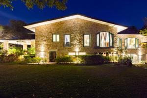 a large brick house at night with lights at 5 Bedroom Villa Amer in Jaipur