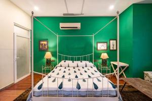 a green bedroom with a bed and a green wall at 5 Bedroom Villa Amer in Jaipur
