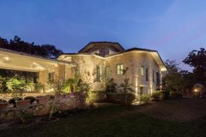 a large brick house with lights on it at night at 5 Bedroom Villa Amer in Jaipur