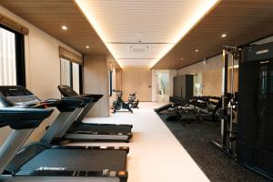 a gym with treadmills and a row of treadms at After Rain Hotel in Chiang Mai