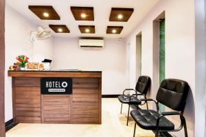 a salon with two chairs and a reception desk at Super Hotel O Tagore Park Laskarhat Formerly Shankar Guest House in Kolkata