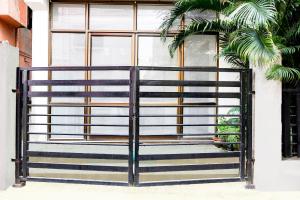 an iron gate in front of a window at Super Hotel O Tagore Park Laskarhat Formerly Shankar Guest House in Kolkata +36 photos