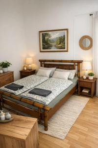 a bedroom with a bed and two tables and a mirror at City Rooms Koblenz Hbf in Koblenz