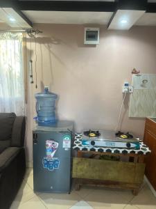 a kitchen with a stove with a blue jug on top at Brighton court in Jomo Kenyatta Airport Nairobi