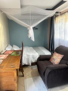 a living room with a couch and a bed at Brighton court in Jomo Kenyatta Airport Nairobi