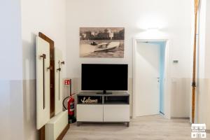 a living room with a television on a tv stand at SANTA MARTA by Design Studio in Bellano