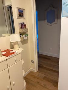 a room with a white dresser and a mirror at Casa Alves in Palmela