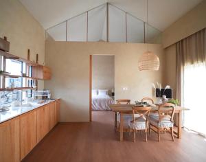 a kitchen and dining room with a table and a bed at 몽중정원 in Sinhŭng i-ri