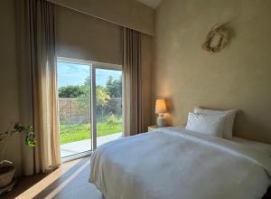 a bedroom with a white bed and a large window at 몽중정원 in Sinhŭng i-ri +19 photos