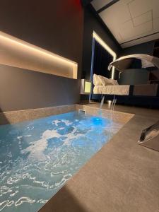 a room with a bathtub in the floor with a bed at Buono Hotel in Naples
