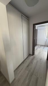 an empty room with white walls and wooden floors at Lion Crib in Bacău +5 photos