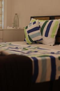 a close up of a bed with pillows on it at Calathea home varkala beach in Varkala