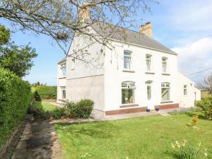 an image of a white house with a yard at Burry House in Swansea