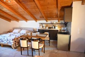 a bedroom with a bed and a table and chairs at Studio Gio in Zakynthos City in Zakynthos