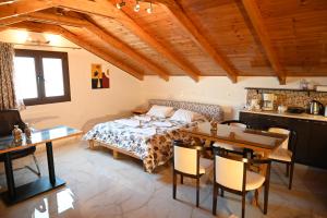 a bedroom with a bed and a table and chairs at Studio Gio in Zakynthos City in Zakynthos +240 photos