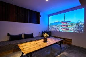 a room with a wooden table and a large window at BLIKIYA Doma in Fujiyoshida